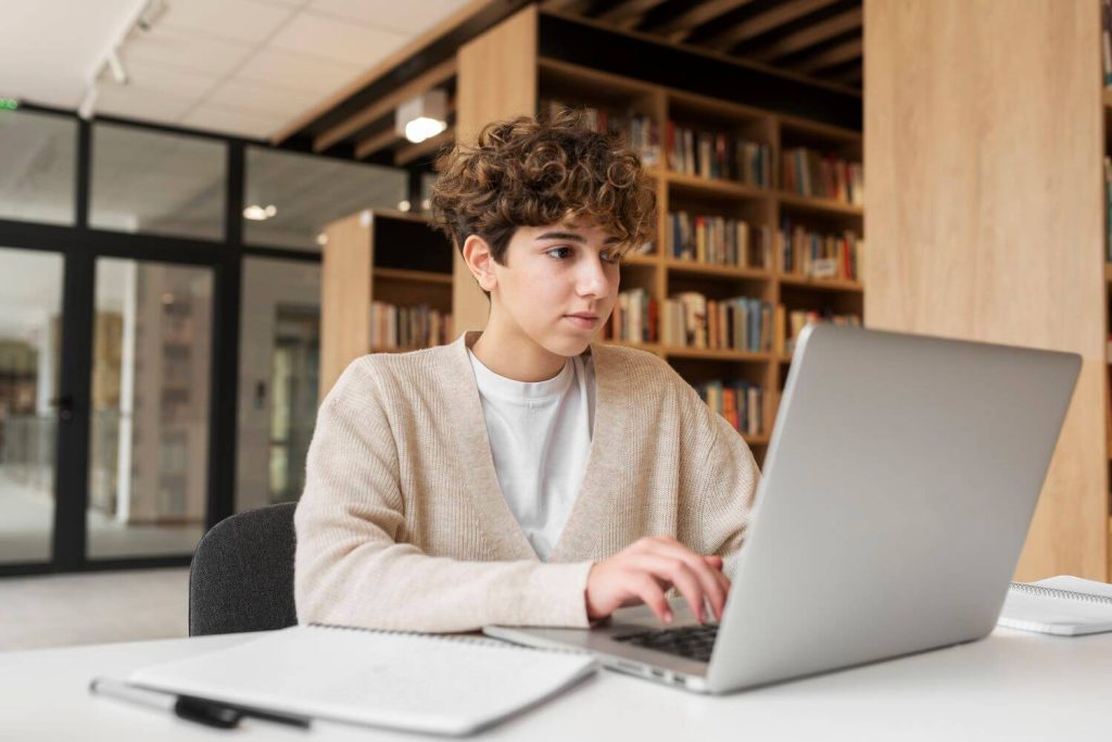 Young student learning library.